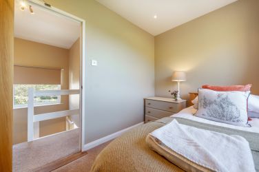 Orrest Head Cottage bedroom one with extra single day bed.