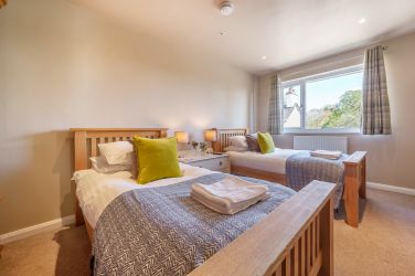 Orrest Head Cottage bedroom 3 twin with wooden beds.