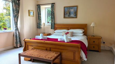 Double bedroom downstairs with views of  private gardens