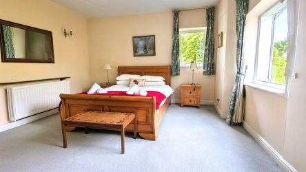 Double bedroom downstairs with views of  private gardens