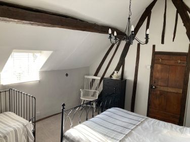 Large family bedroom with  a king size bed and a single bed