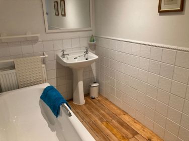 En-suite bathroom for the family room, shower over bath.