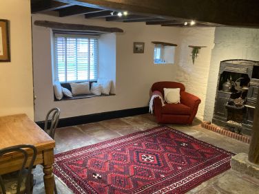 The middle room with a window seat and armchairs