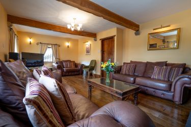 Spacious sitting room with wood burning stove and large flat screen T.V.