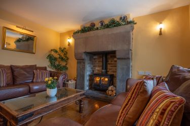 Spacious sitting room with wood burning stove and large flat screen T.V.