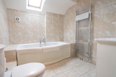 Main bathroom with large bath, separate shower, toilet and wash basin.