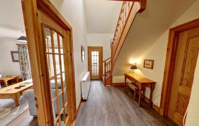 Downstairs hallway. The cottage has wood effect flooring throughout downstairs living areas.