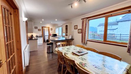 Open plan dining and kitchen area with opening french doors leading to the living area