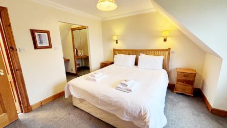 Master bedroom with super kingsize bed, mirrored built in wardrobes and vanity area. Bedroom 1.