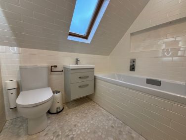 Family bathroom with full size 1800mm bath and overhead rain shower.