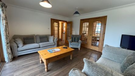 Large living area with flat screen TV and suites.
