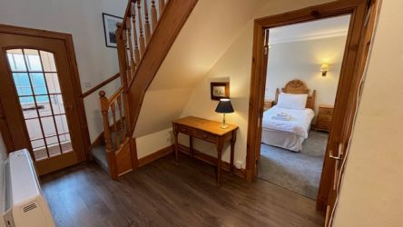 Downstairs hallway leading to the kitchen, living room and twin bedroom.