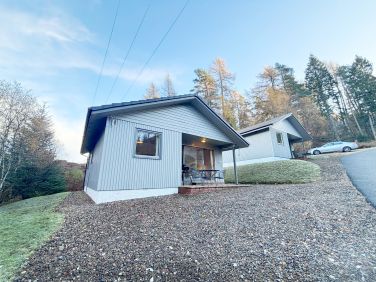 Fisher Lodge with car parking immediately outside the lodge.