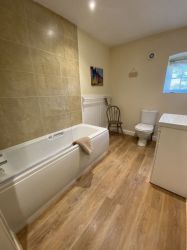 Family bathroom with shower over bath.