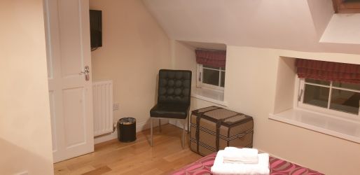 Master bedroom looking towards windows.