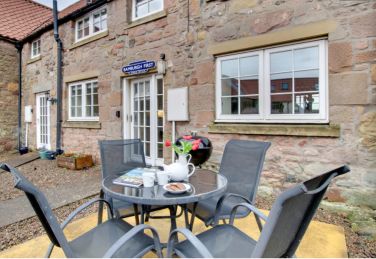 Outdoor dining area with patio table, 4 chairs and BBQ