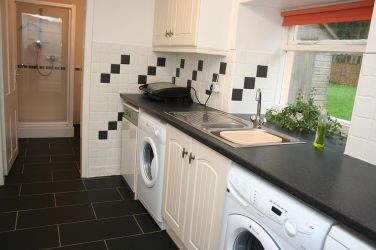 Utility- dishwasher, washing maching, tumble dryer, microwave. leading to downstairs shower room