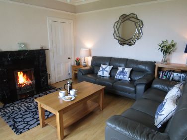 Sitting room with open fire & sea view