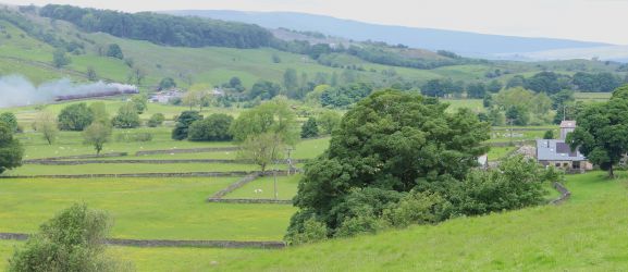 Steam trains pass by most weeks on The Settle to Carlisle Railway. Meadow View Barn is on the right.