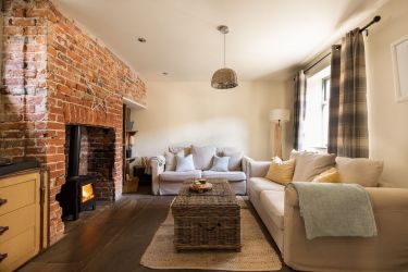 Cosy sitting room with log burner, smart TV , and plenty of games for rainy days