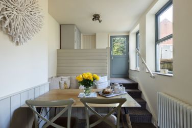 The kitchen contains a pretty seating/eating area