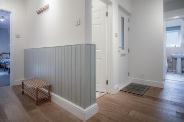 Spacious hallway with coat rack and shoe rack