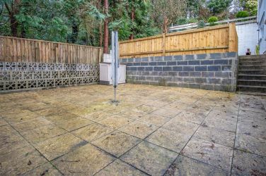 Enlcosed lower terrace with washing line or for a kick about