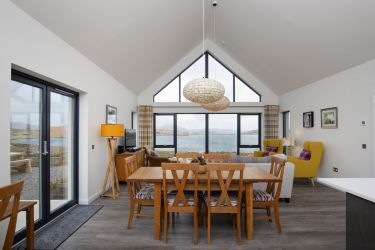 A modern dining area that seats 8 and offers stunning views across the loch.
