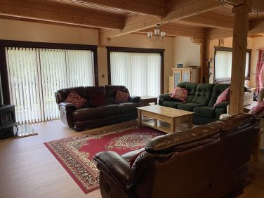 Large open-open plan living area with TV and wood-effect stove