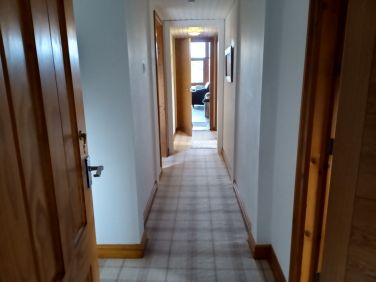 Corridor leading to bedrooms and bathrooms