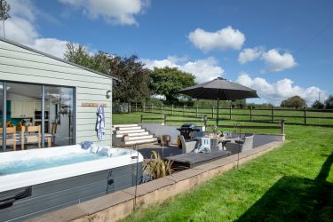 The hot tub on the patio, with stunning views across the fields.