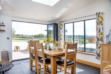 The dining area with oak dining table and 6 chairs.
