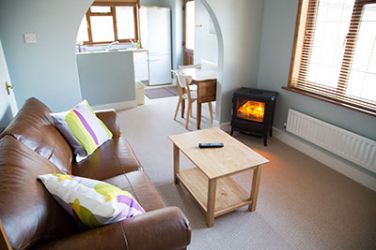 There is a cosy living room with an electric heater,
