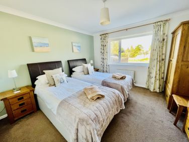 Second bedroom with two full size single beds