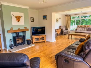 Spacious living room with log burner