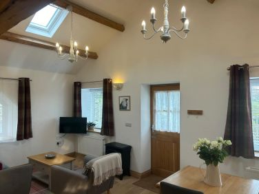 Bright and airy living/ dining space with 3 large picture windows