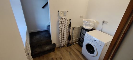 Utility room with washing machine