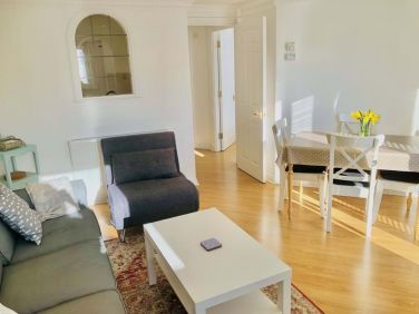 Comfortable lounge leading to kitchen and separate bedroom