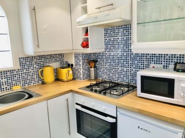 Kitchen with microwave oven, stove and oven
