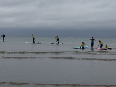Stand up paddleboarding lesson with Suds on a calm Sandend Bay