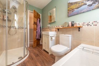 Bright bathroom with large walk in shower and rainshower head
