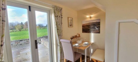 Attractive dining alcove with table for 2 and comfortable seating