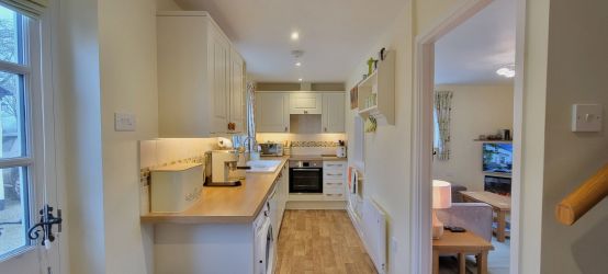Fully fitted kitchen with electric hob & oven, microwave, toaster, washer/dryer, fridge.
