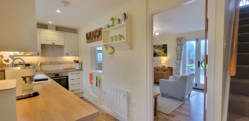 Kitchen leading to sitting room and first floor bedroom and bathroom