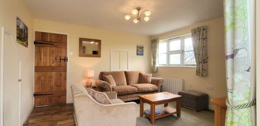 Sunny sitting room with spacious seating area.