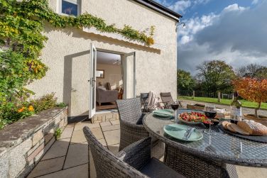 Enjoy dining or relaxing on this sunny patio, which is in the sun from morning till sunset