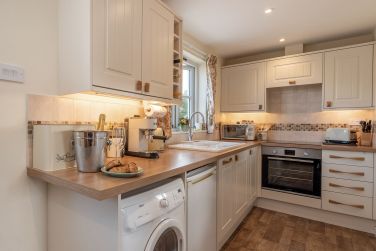 Fully equipped kitchen with window overlooking fields and Dartmoor views