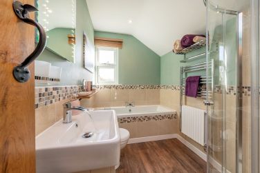 Bathroom with double ended bath and walk in shower