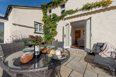 The sunny patio is perfect for al fresco dining or an evening barbecue
