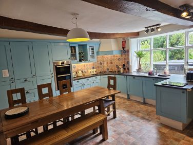 Oak kitchen table which extends out with extra chairs